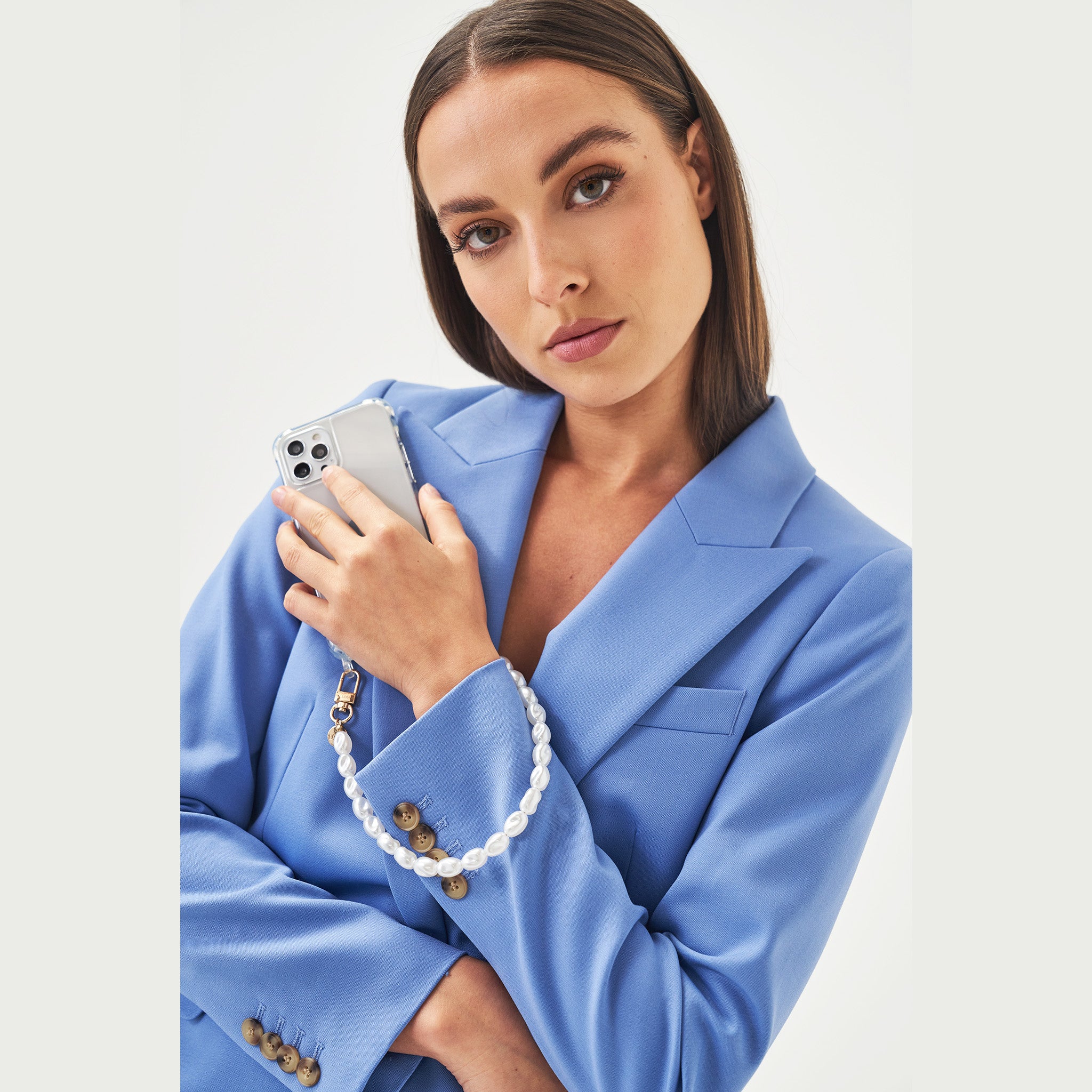 Pearl phone wristlet. iPhone charm with pearls. Emily in Paris. Ashley park. Pearl phone strap