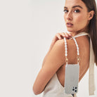Pearl phone wristlet. iPhone charm with pearls. Emily in Paris. Ashley park. Pearl phone strap
