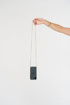 Crossbody phone case. Modular Smartphone cases. Phone Harness. Lanyard. Strap. Phone accessories. Xouxou. Casetify. Bandolier style. Tde. Corded phone case. Hands-free phone accessories. Phone necklace. Mini-bag. Gold phone chain. Phone chain gold-plating.