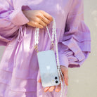 Corded phone case. Phone case with pearl strap. Emily in Paris. Ashley Park. Mindy. Pearly phone chain. Phone chain with pearls. Clear phone case. Custom smartphone accessories. Phone case with Pearl wristlet. pearl Chain for your phone. Phone lanyard with pearls. Double phone cord with pearls. Pearl phone bracelet. wristlet. wristband. phone Charm. phone Charms. phone Wristlets. modular phone case. iPhone straps. 13 pro max. mini. Lanyard. iPhone cords. mini phone bag. phone-necklace. Phone purse.