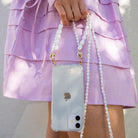 Crossbody phone case. Phone case with pearl strap. Emily in Paris. Ashley Park. Mindy. Pearly phone chain. Phone chain with pearls. Clear phone case. Custom smartphone accessories. Phone case with Pearl wristlet. pearl Chain for your phone. Phone lanyard with pearls. Double phone cord with pearls. Pearl phone bracelet. wristlet. wristband. phone Charm. phone Charms. phone Wristlets. modular phone case. iPhone straps. 13 pro max. mini. Lanyard. iPhone cords. mini phone bag. phone-necklace. Phone purse. 