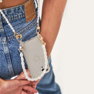 Crossbody phone case. Phone case with pearl strap. Emily in Paris. Ashley Park. Mindy. Pearly phone chain. Phone chain with pearls. Clear phone case. Custom smartphone accessories. Phone case with Pearl wristlet. pearl Chain for your phone. Phone lanyard with pearls. Double phone cord with pearls. Pearl phone bracelet. wristlet. wristband. phone Charm. phone Charms. phone Wristlets. modular phone case. iPhone straps. 13 pro max. mini. Lanyard. iPhone cords. mini phone bag. phone-necklace. Phone purse.