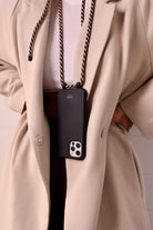 Phonecasewithcord.Cordedphonecase.Smartphonestrap.Lanyard.Modularphoneaccessories.Xouxou.Idealofsweden.Maisondesabre.carrie-case.string. phone case with strap. lanyard. xouxou. phone cords. Modular phone cases. bandolier style. ideal of Sweden. 